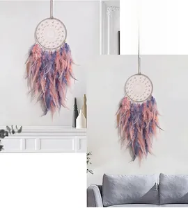 Detail of pink and purple gradient feathers on a dreamcatcher with white bead accents