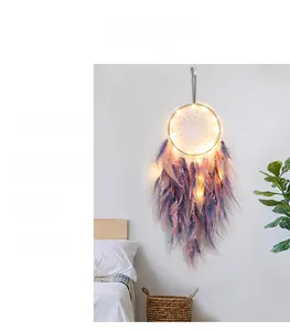 Dreamcatcher wall hanging with pink gradient feathers, white pearls and warm LED lights
