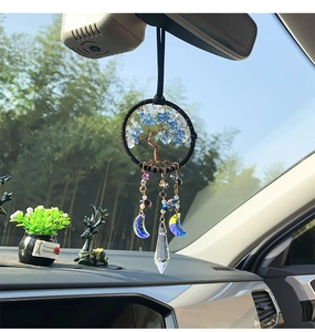 Close-up of handmade wire-wrapped Tree of Life car charm with crystal moon and prism
