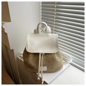 Detail of straw woven texture and white leather flap on a summer drawstring backpack