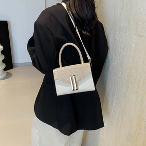 Elegant white crossbody bag with champagne gold glitter flap and metal bar clasp