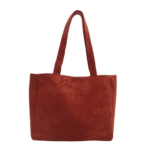 Red corduroy shoulder bag with traditional Chinese floral pattern and windowpane motif