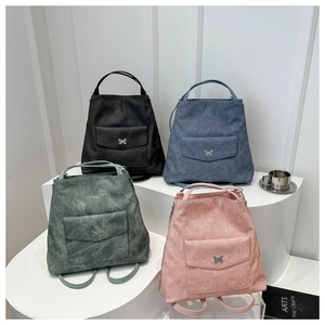 Détail de sacs à dos multicolores en cuir mat avec boucles papillon argentées élégantes