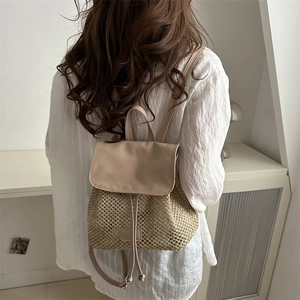Mini woven straw backpack for women with leather flap and drawstring closure in summer style