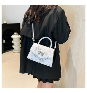 White minimalist tote bag with lilac butterfly prints and a silver bow clasp detail