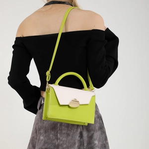 Trendy avocado green and white patchwork crossbody bag with gold buckle on model