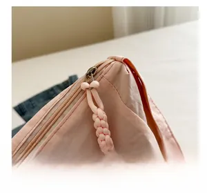 Close-up of smooth zipper with pink woven puller on high-quality nylon fabric