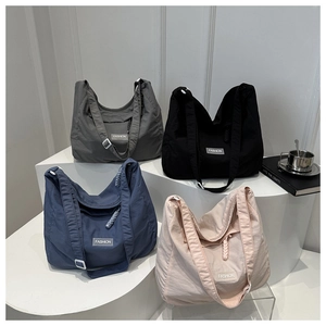Simple nylon tote bags in four colors with wide shoulder straps and fashion labels