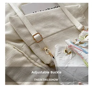 Detail of white leather bag with FF pattern and gold metal adjustable strap buckle