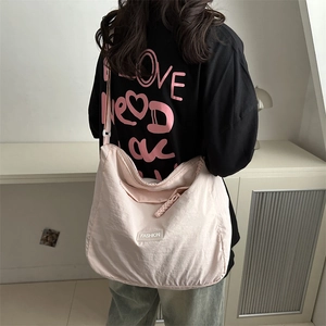 Pink nylon crossbody bag for women with fashion label and braided zipper detail