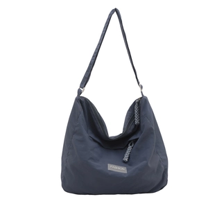 Minimalist large capacity blue nylon tote bag with fashion tag on white background