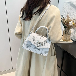 Minimalist white tote bag with black butterfly print and silver bow clasp decoration