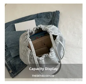 Macro shot showing the spacious capacity of this grey quilted drawstring bucket bag