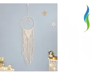 Close-up of bohemian large moon dream catcher with white cotton tassels and warm LED lights