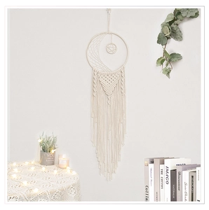 Detailed view of large moon dream catcher with handmade macrame cotton tassels for home decor