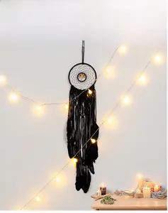 Detail of black macrame tree of life dreamcatcher with real feathers and LED lights
