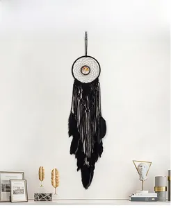 Detail of bohemian black woven dreamcatcher with life tree beads and natural feathers