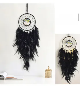 Macro shot of black dream catcher feathers and beads with Tree of Life center design