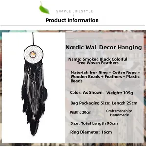 Detailed view of handmade black bohemian dream catcher with woven tree design and feathers