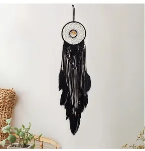 Detail of bohemian dream catcher with black feathers and woven life tree design