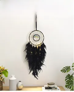 Detail of life tree dream catcher with black feathers and warm LED fairy lights