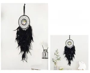 Detail of black dream catcher with tree of life beadwork and hanging soft feathers