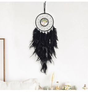 Detail of black dream catcher with life tree and feathers for wall hanging decor