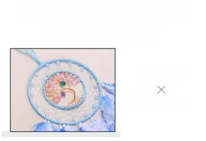 Detailed close-up of blue dreamcatcher featuring a handcrafted Tree of Life with beads