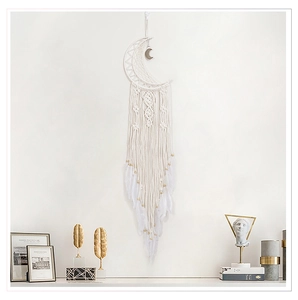 Detailed view of white moon dreamcatcher with handmade macrame fringe and feathers