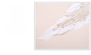 Detail showing natural white feathers and wooden beads on a large handmade dream catcher