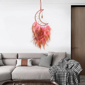 Handmade crescent moon dreamcatcher wall hanging with vibrant orange feathers and beads
