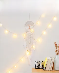 Détail d'un attrape-rêves Arbre de Vie tissé avec lumières LED chaudes et plumes blanches