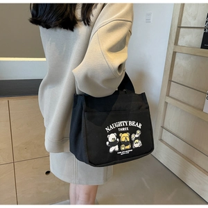 Black canvas tote bag featuring cute cartoon bears and naughty bear three print details