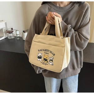 Detail of canvas tote bag featuring cute cartoon bear prints and practical outer pocket