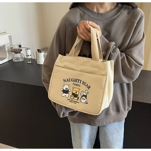 Close-up of cute Naughty Bear canvas tote bag with practical front pocket and thick handle