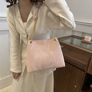 Elegant pale pink tote bag for women featuring fashion embossed design and chain strap