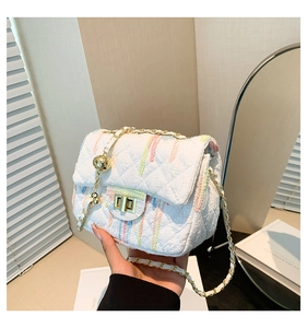 Quilted white crossbody bag with multi-color stripes and gold chain strap detailing