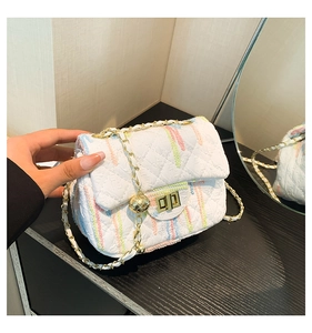 Detail of white quilted crossbody bag with colorful vertical stripes and gold chain strap