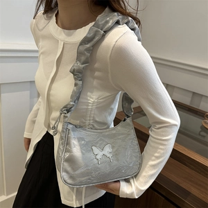 Chic silver crescent underarm bag with pleated strap and metallic butterfly accent