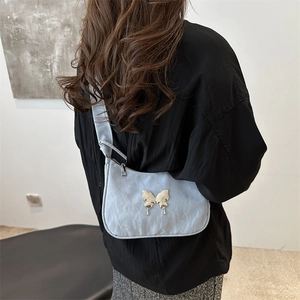 Fashionable light blue crescent underarm bag with silver butterfly and pleated texture