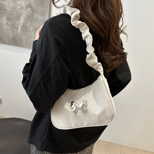 Minimalist cream crescent shoulder bag with liquid metal butterfly and ruched strap
