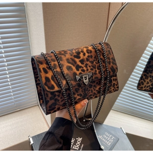 Detail of leopard print shoulder bag with metallic chain strap and lock closure