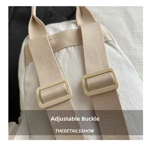 Detail of adjustable nylon shoulder straps with plastic buckles on a cream backpack