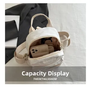 Internal view of beige canvas backpack showing large capacity for mobile and sunglasses