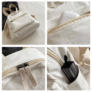 Detail view of mini backpack compartments for earphones and lipsticks with zip