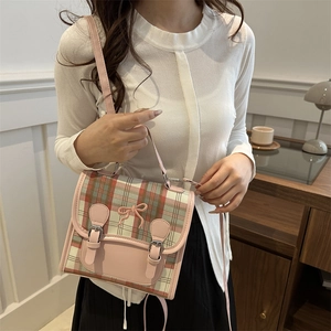 Pink and green plaid crossbody bag with embroidered bow and buckle detail
