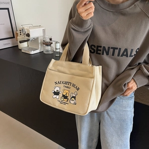 Chic beige canvas tote bag with cute cartoon bear prints and comfortable webbed handles
