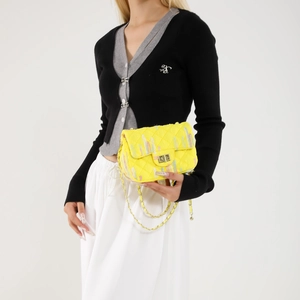 Bright yellow quilted crossbody bag with colorful embroidery and gold chain strap