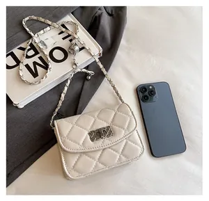 Quilted leather mini bag showing size comparison with a smartphone and accessories