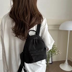 Minimalist black nylon backpack for women with adjustable straps and casual style